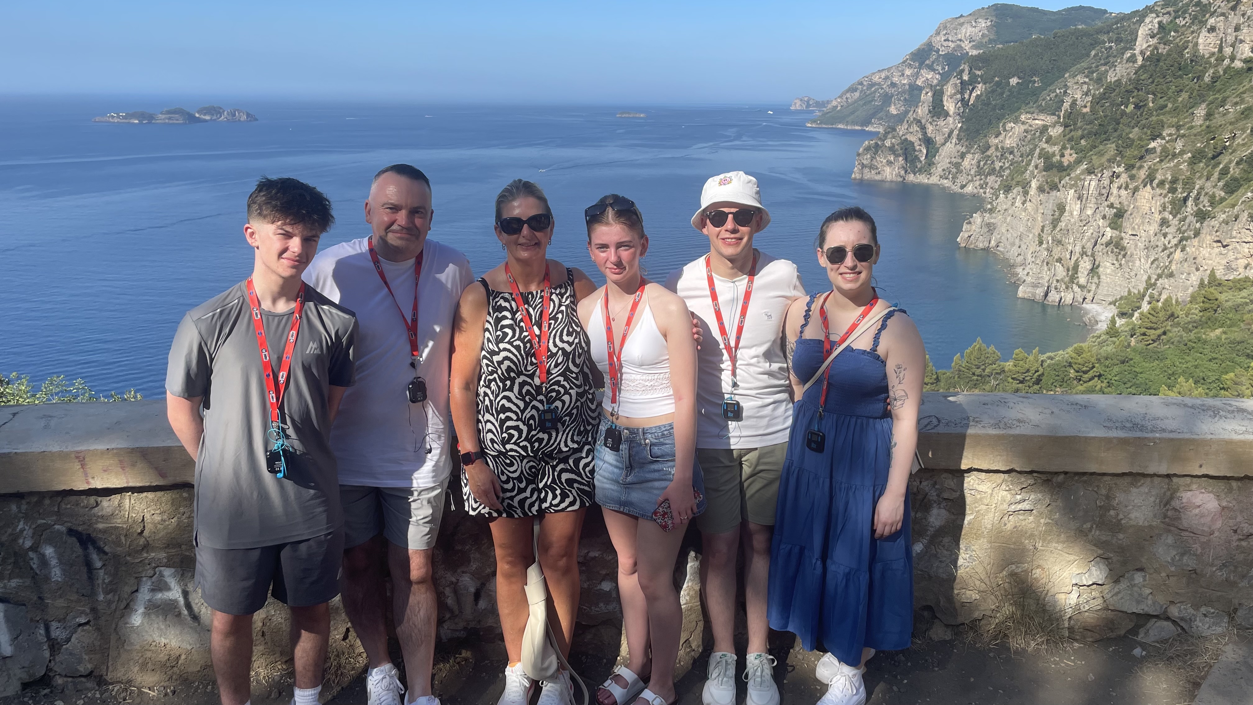 The six of us together overlooking the blue sea and dramatic coastline